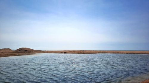 Ocean lake beside beach with summer sky background.