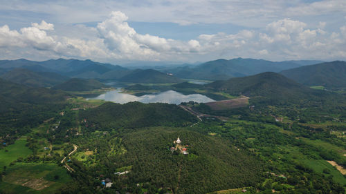 Scenic view of field and mountains against sky