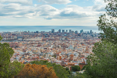 High angle view of townscape by sea against sky