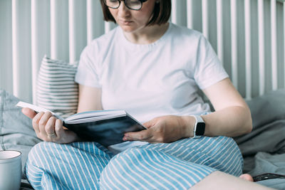 Midsection of woman using mobile phone