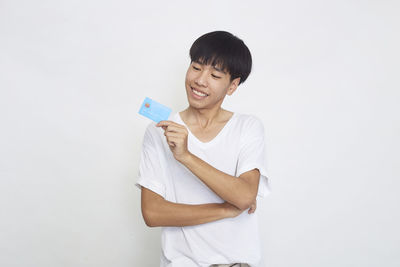 Smiling boy standing against white background