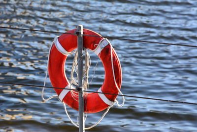 Close-up of red boat hanging on lake