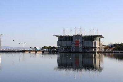 Building by sea against clear sky