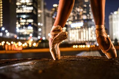 Low section of ballet dancer dancing on floor