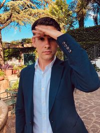 Portrait of young man standing outdoors