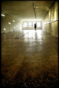 Rear view of woman in corridor