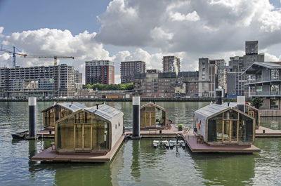 Five tiny houses used as holiday accommodation floating in rijnhaven harbour in rotterdam