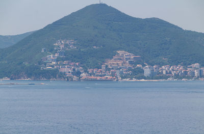 Scenic view of sea and buildings against sky