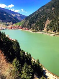 Scenic view of lake by mountains against sky