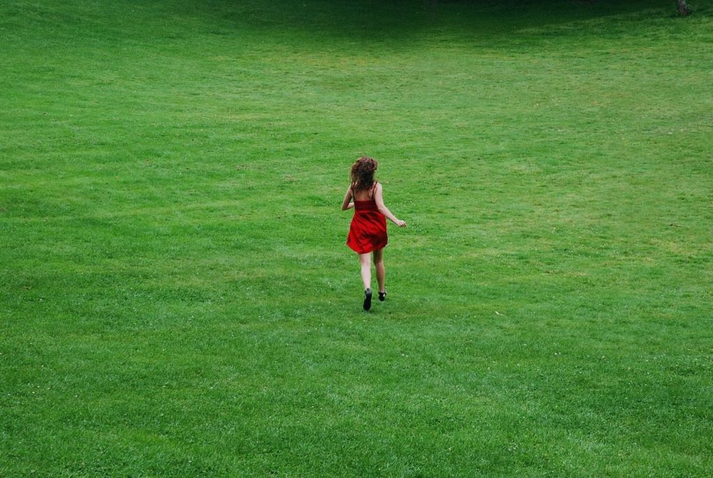 full length, grass, casual clothing, lifestyles, green color, leisure activity, rear view, walking, field, standing, grassy, person, childhood, growth, nature, day, outdoors, front view