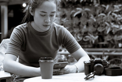 Mid section of man holding coffee cup