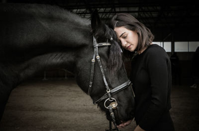 Mid adult woman in stable