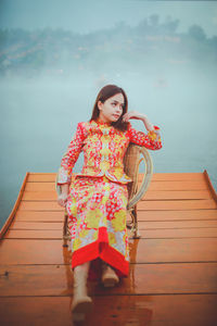 Asian woman wearing cheongsam traditional red dress on chinese new year travel.