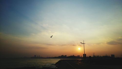 Silhouette of city at sunset