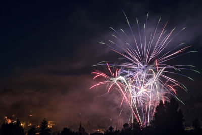 Low angle view of firework display at night