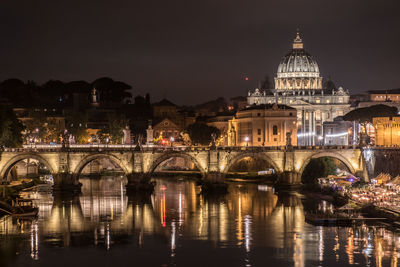 Illuminated buildings against sky at night