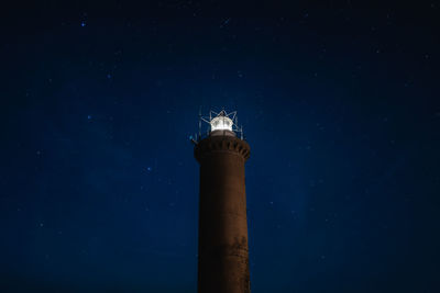 Low angle view of lightpuse tower against clear star sky at night