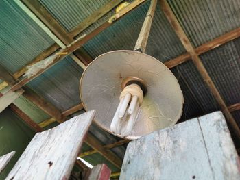 Low angle view of electric lamp hanging on ceiling