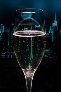 Close-up of beer glass against black background