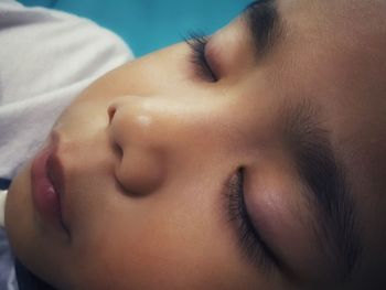 Close-up of cute boy sleeping at home