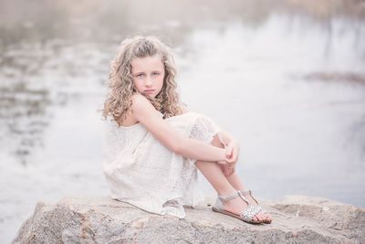 Portrait of a girl sitting outdoors