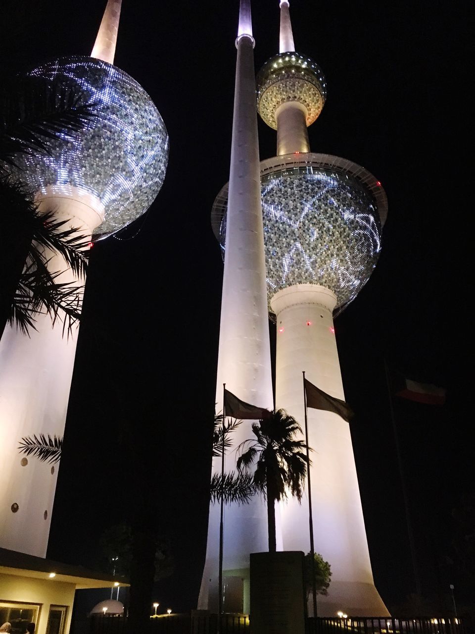 LOW ANGLE VIEW OF ILLUMINATED BUILDING AT NIGHT