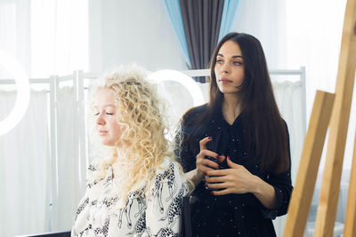 Woman looking away while standing in corridor