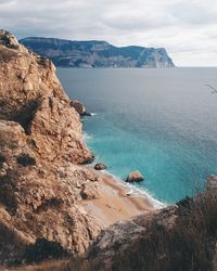 Scenic view of sea and mountains against sky