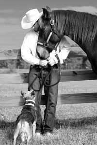 Cowboy with dog and horse at ranch