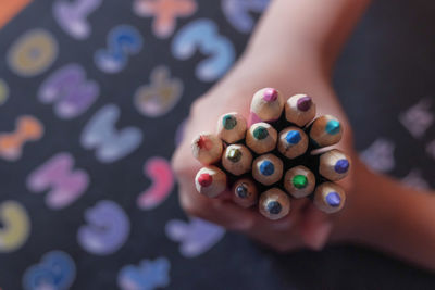 Child boy hand holding color pencils