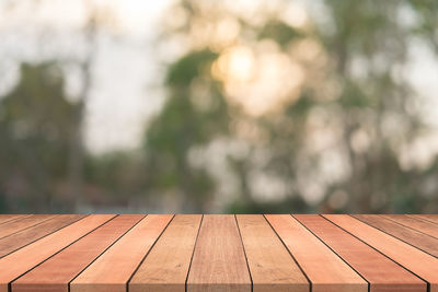 Close-up of wooden bench on footpath