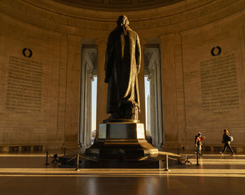 Statue standing against wall