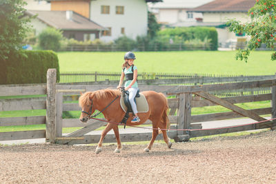 Full length of man riding horse