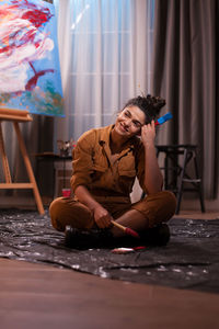 Smiling woman looking away while sitting at home