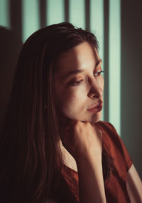 Serious woman sitting at home