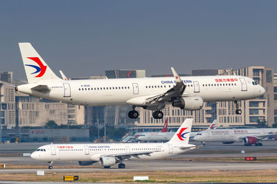 Airplane on airport runway against sky