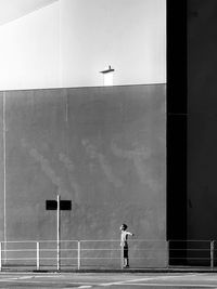 Rear view of man standing by building