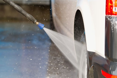 Close-up of water splashing on car