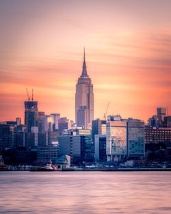 Buildings in city at sunset