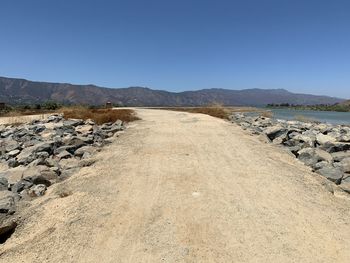 Scenic view of land against clear blue sky