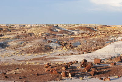 Scenic view of rock formations against cloudy sky