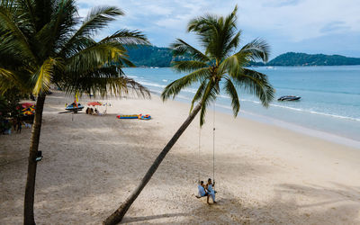 People on beach against sky