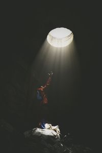 Low angle view of illuminated lamp at night