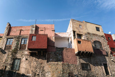 Low angle view of old building against blue sky