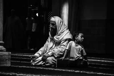 Rear view of people sitting in temple