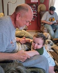 Father and daughter sitting on floor