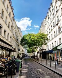 Street amidst buildings in city against sky