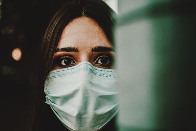 Close-up portrait of woman wearing mask