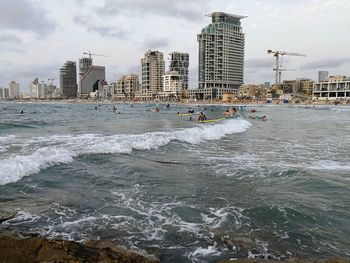 Scenic view of sea and city against sky