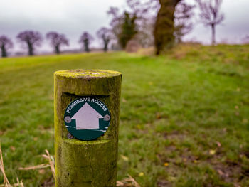 Close-up of wooden post on field